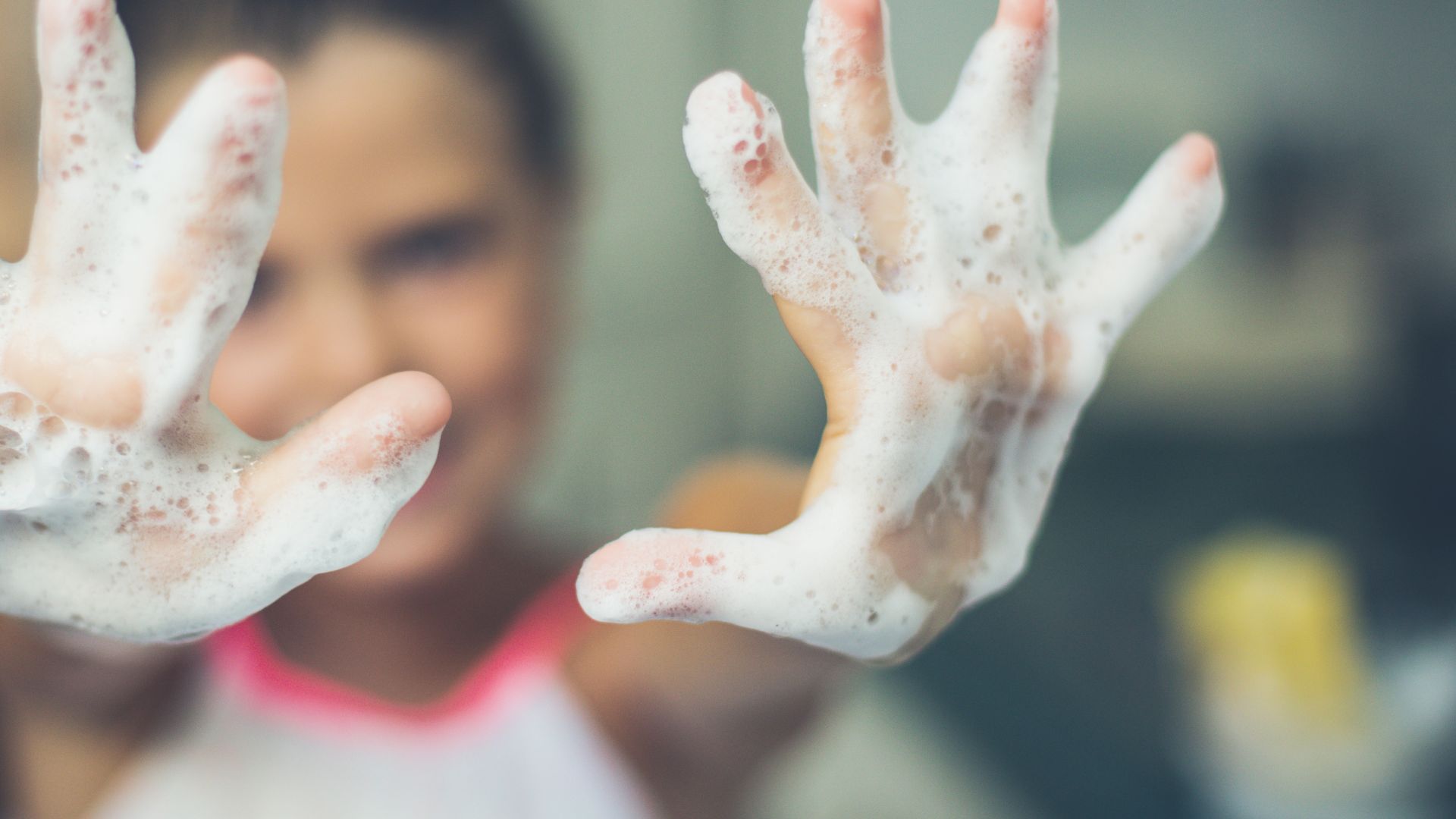 Child with soup on hands