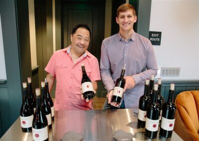 Two men showing up Handwritten Wine bottles