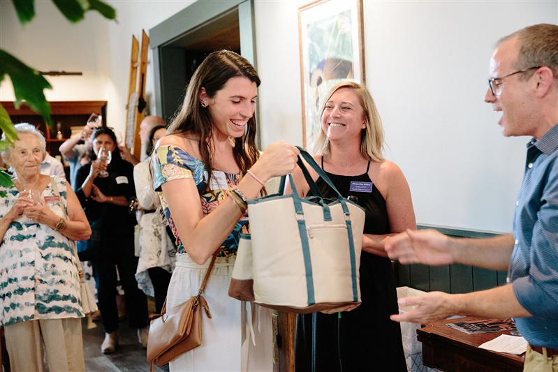 A lady winning a prize bag